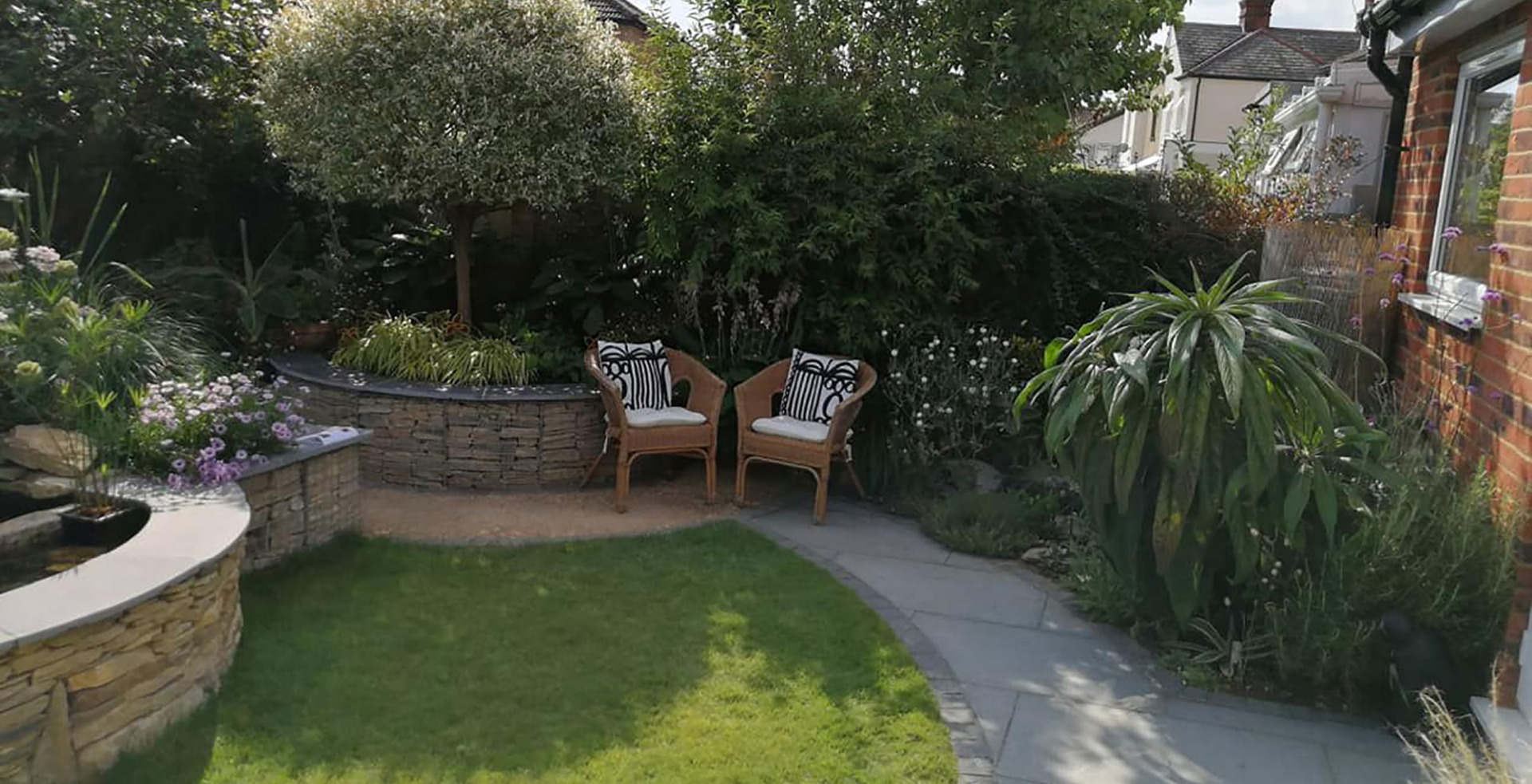Contemporary garden design in St Albans, Hertfordshire with stone filled gabion retaining walls and vegetable garden.
